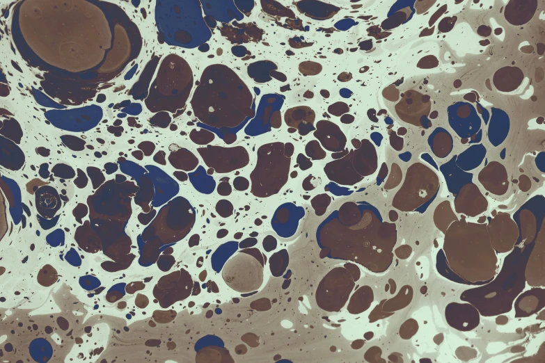 an image of brown and blue substance in liquid