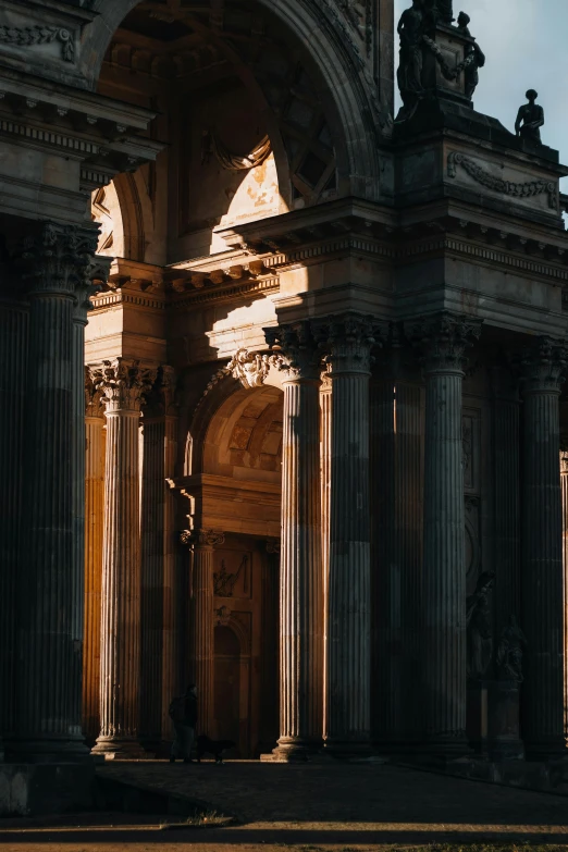 an ornate building that has columns and statues on it