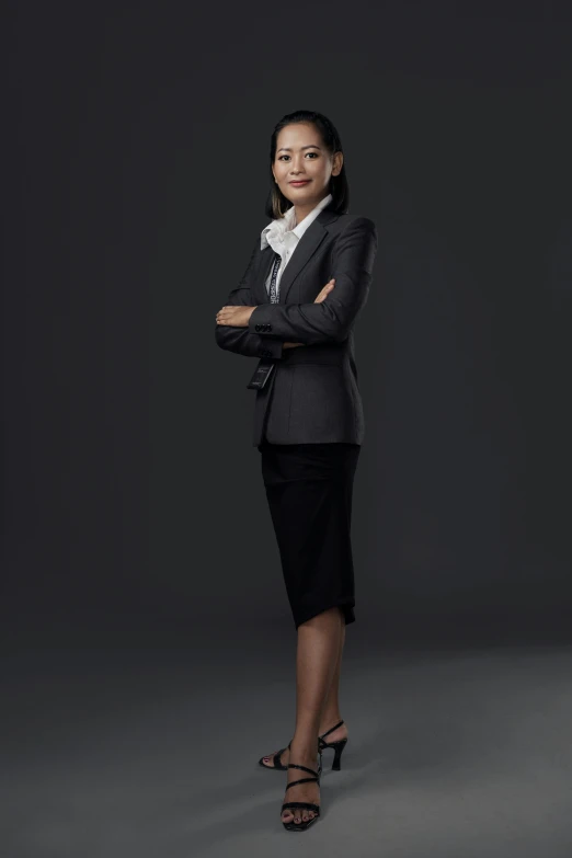 a woman in business clothes posing for a picture