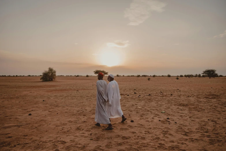 there is a man standing alone in the desert