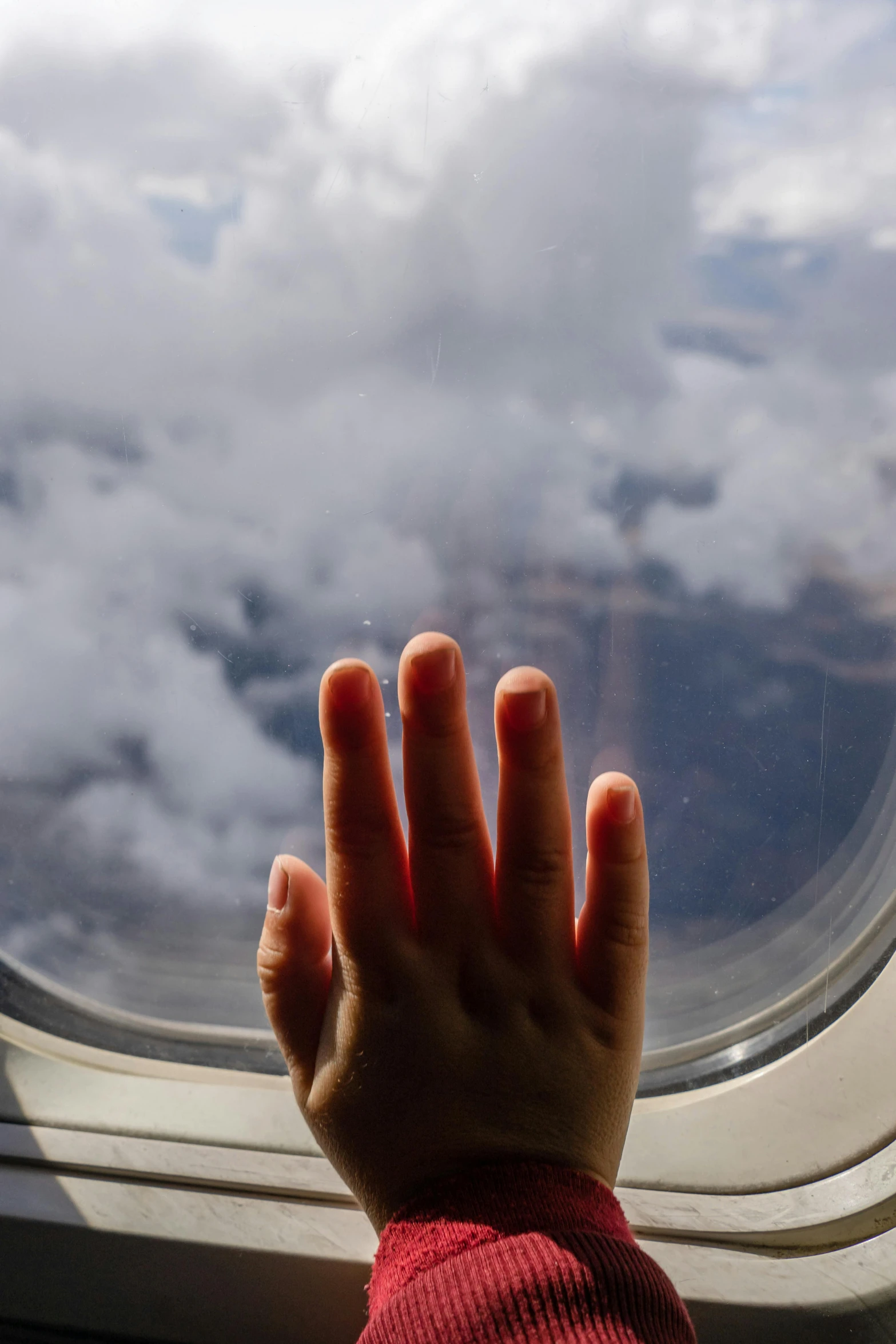 a hand that is in front of a window