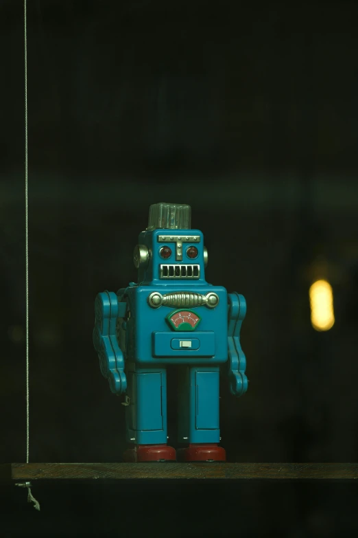 blue toy robot with bright eyes and no arms