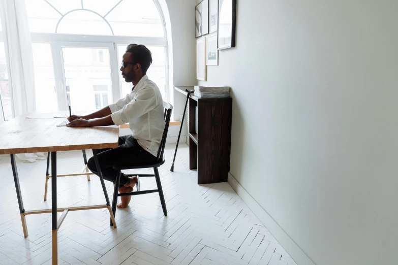 a person sitting at a wooden table