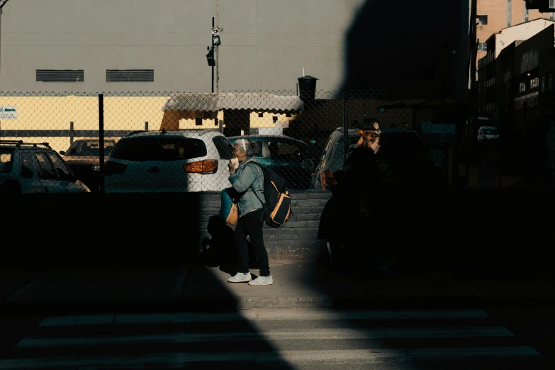 two people holding umbrellas near buildings in city