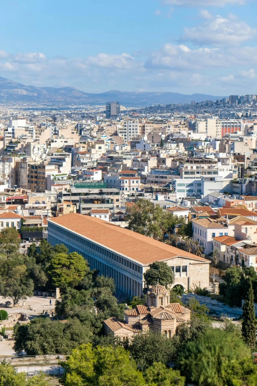 a city has white buildings with red roofs