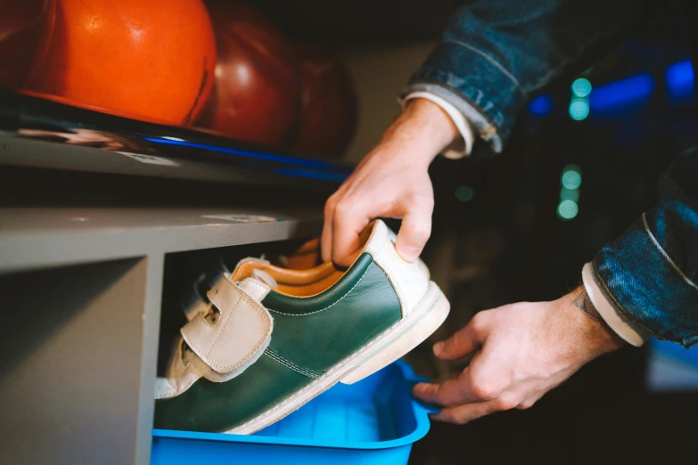 a man putting on shoes with his feet in the closet