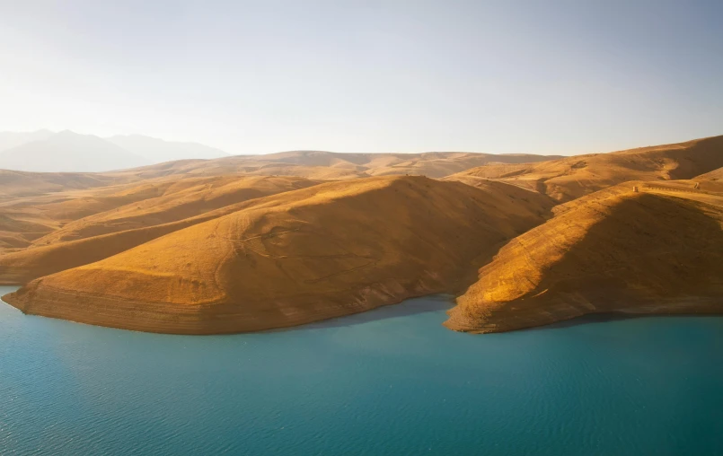 large lake surrounded by lush green hills and water