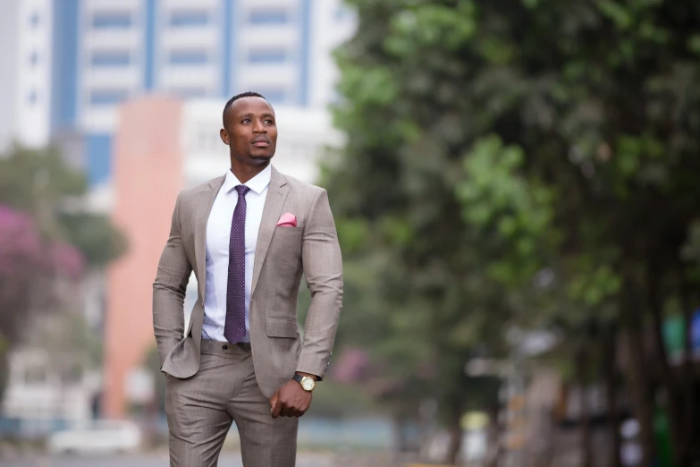 a man in a suit poses for a picture