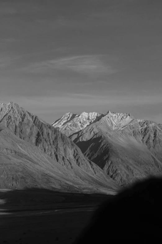 the view of the mountains at an intersection of highway and road