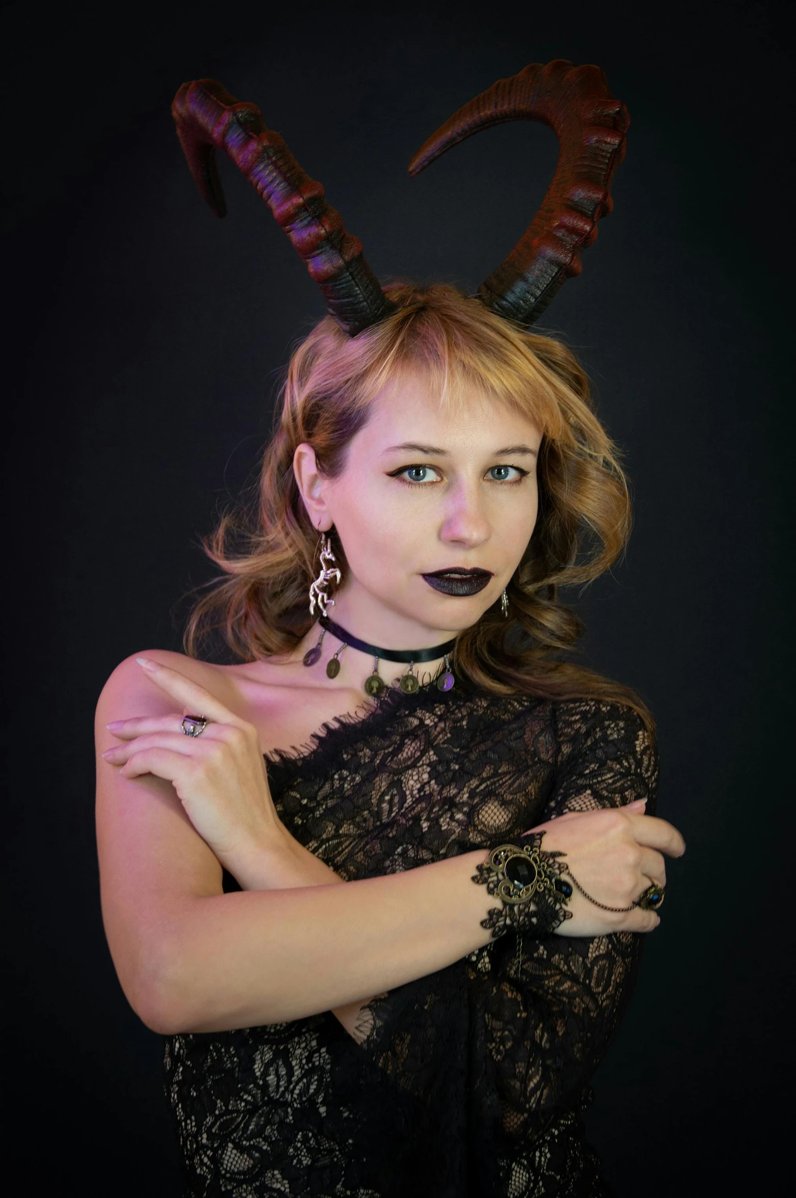 woman with dark makeup and horns in dress