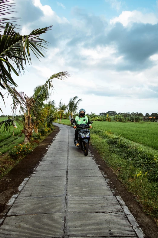 a person is riding a motorcycle down a country road