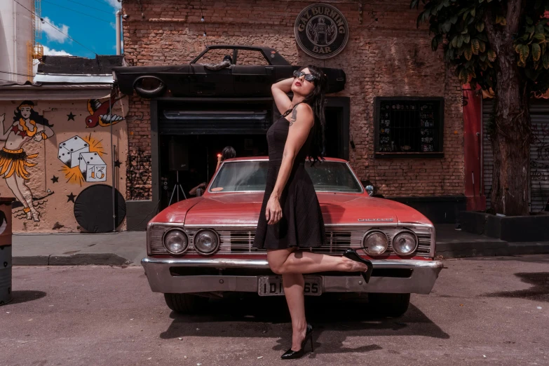 a beautiful young woman leaning on the car in a city