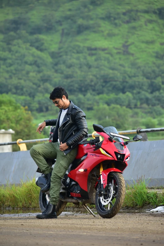 a person on a red motorcycle on the street