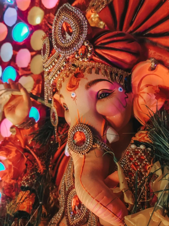 a colorfully painted ganesh statue with many lights on it