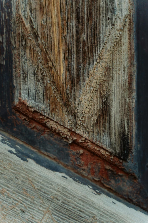 the corner of a piece of wood with some water on it