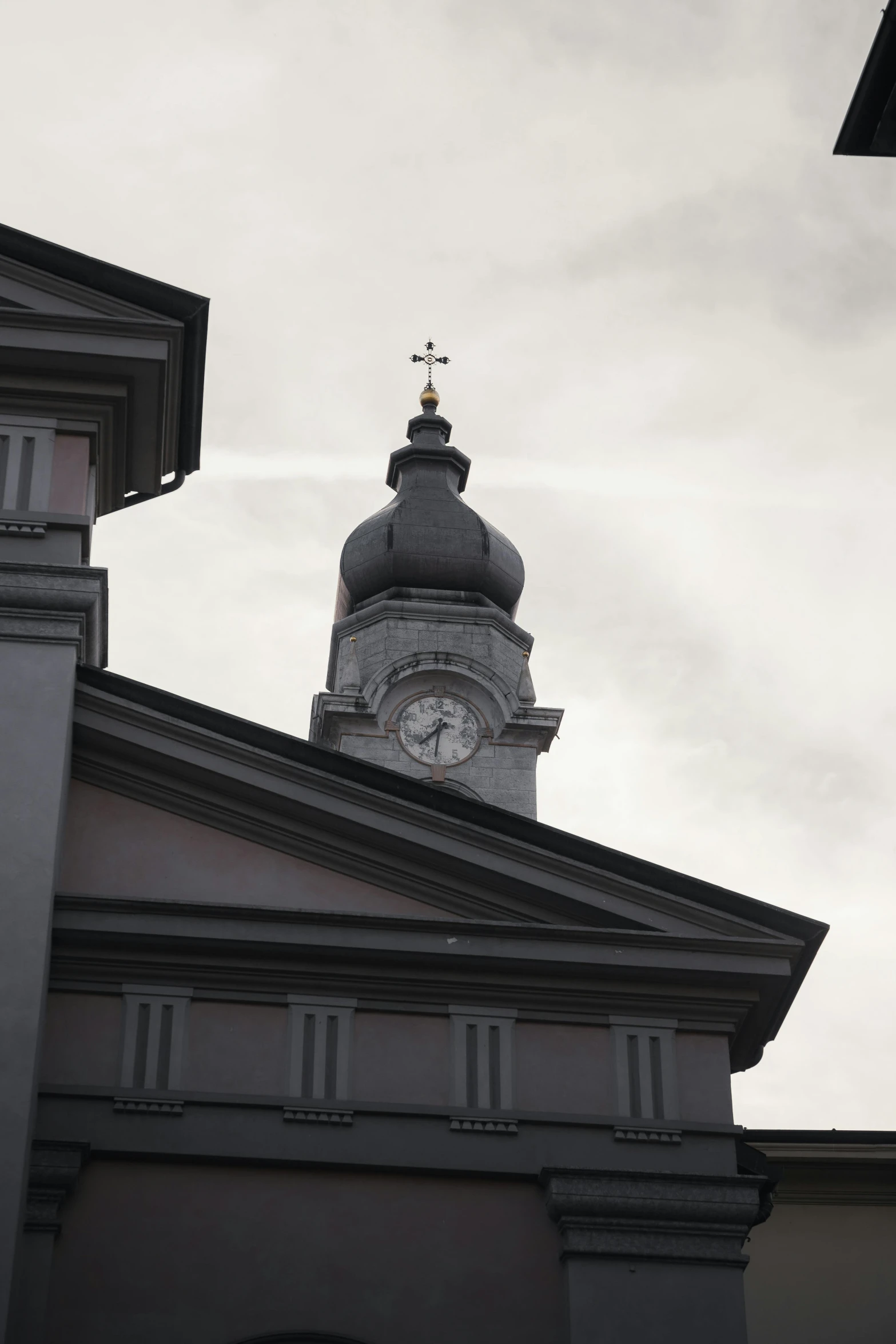 view from the roof of an old building towards a clock tower