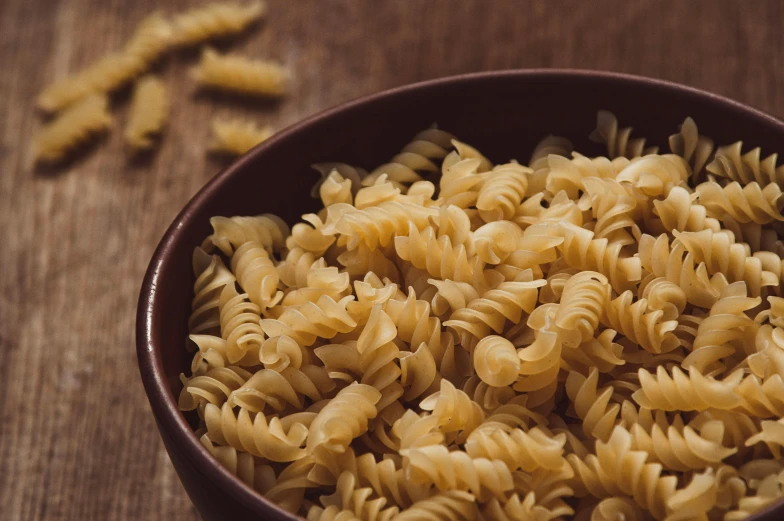 the table has a bowl full of noodles