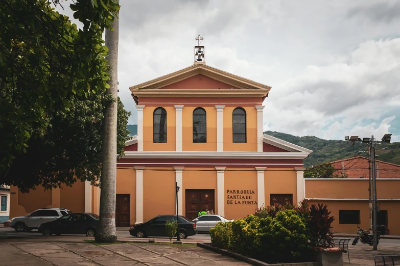 a church with some cars parked in front of it