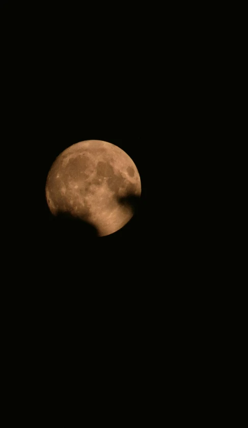 the moon is bright, and a black background shows light orange