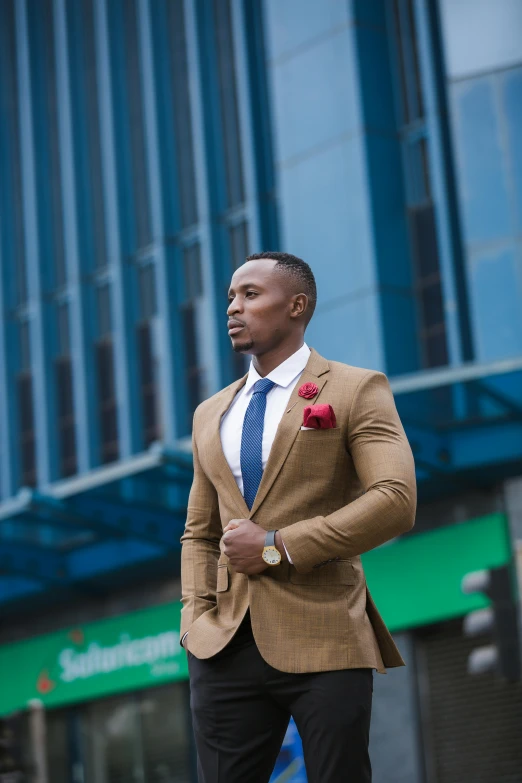 a black man in a business suit with a red rose on his lapel