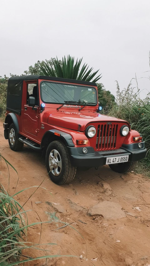 red jeep on dirt road in rural area