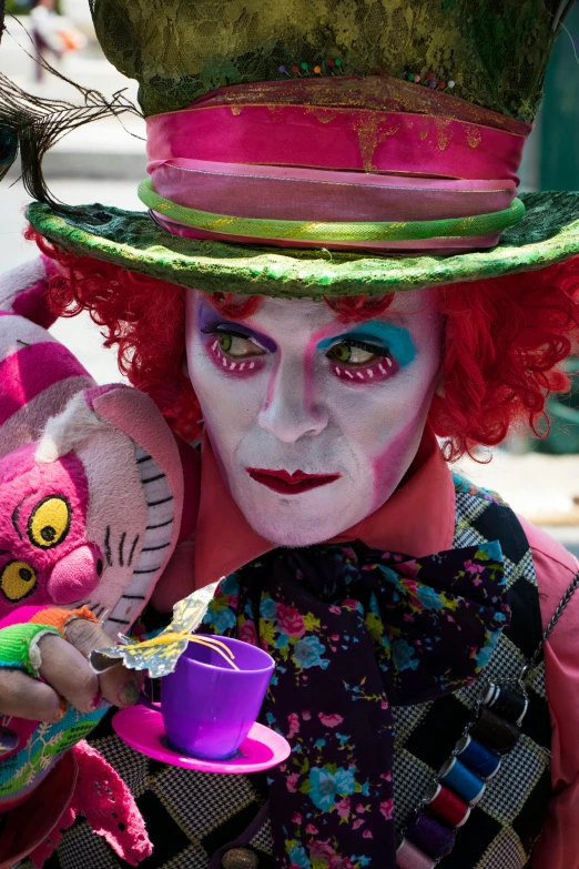 man with clown makeup and a pink costume