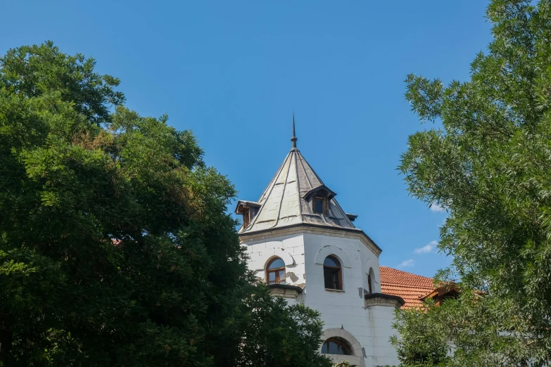 an old building with a bell tower sits among the trees