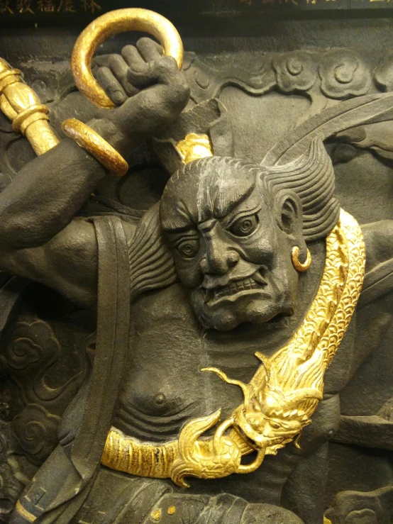closeup of a statue with a horned head