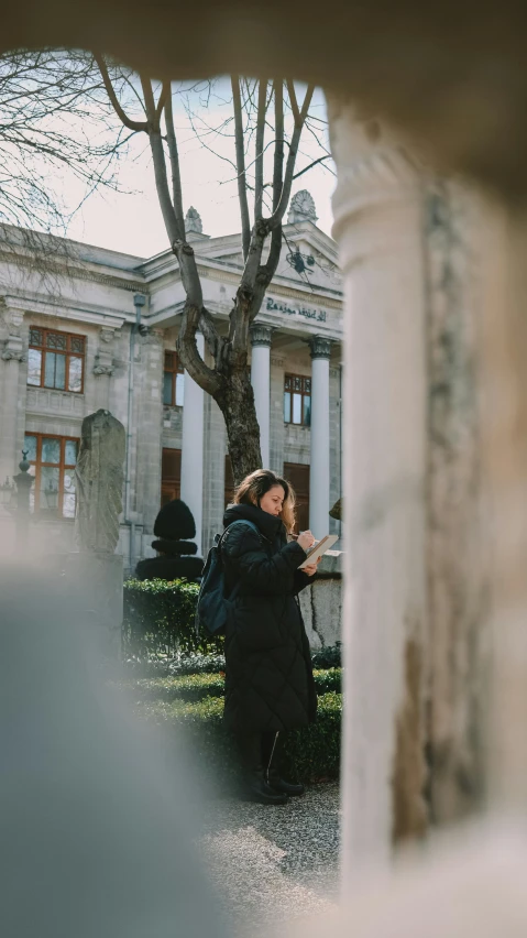 couple taking a picture while standing under tree during daytime