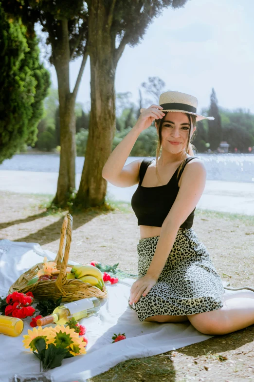 a beautiful woman sitting on top of a picnic table