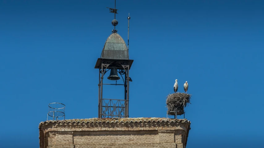 an image of a building and clock with sky in background