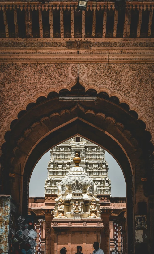 an archway with a small shrine in the middle