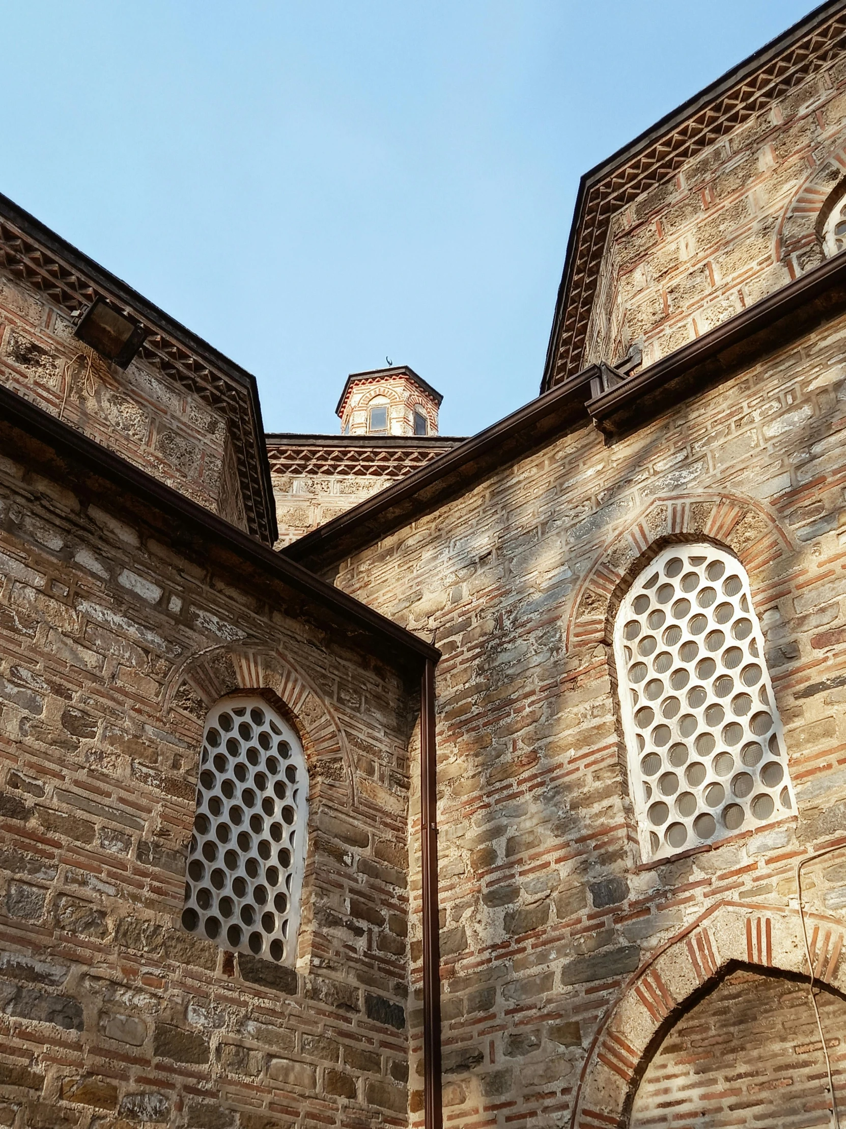 a large brick building with two arched windows