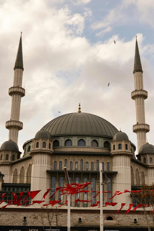 an ornate building has red streamers on it