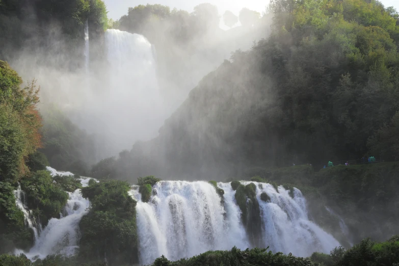 the waterfall on a misty day has many cascading