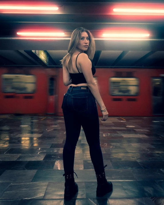 a woman standing on a tile platform looking at the camera