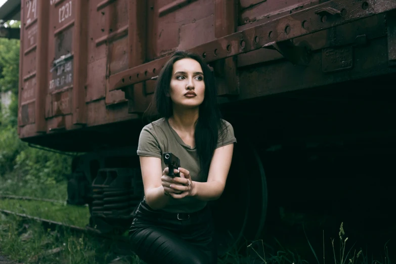 a woman is kneeling down in front of the train