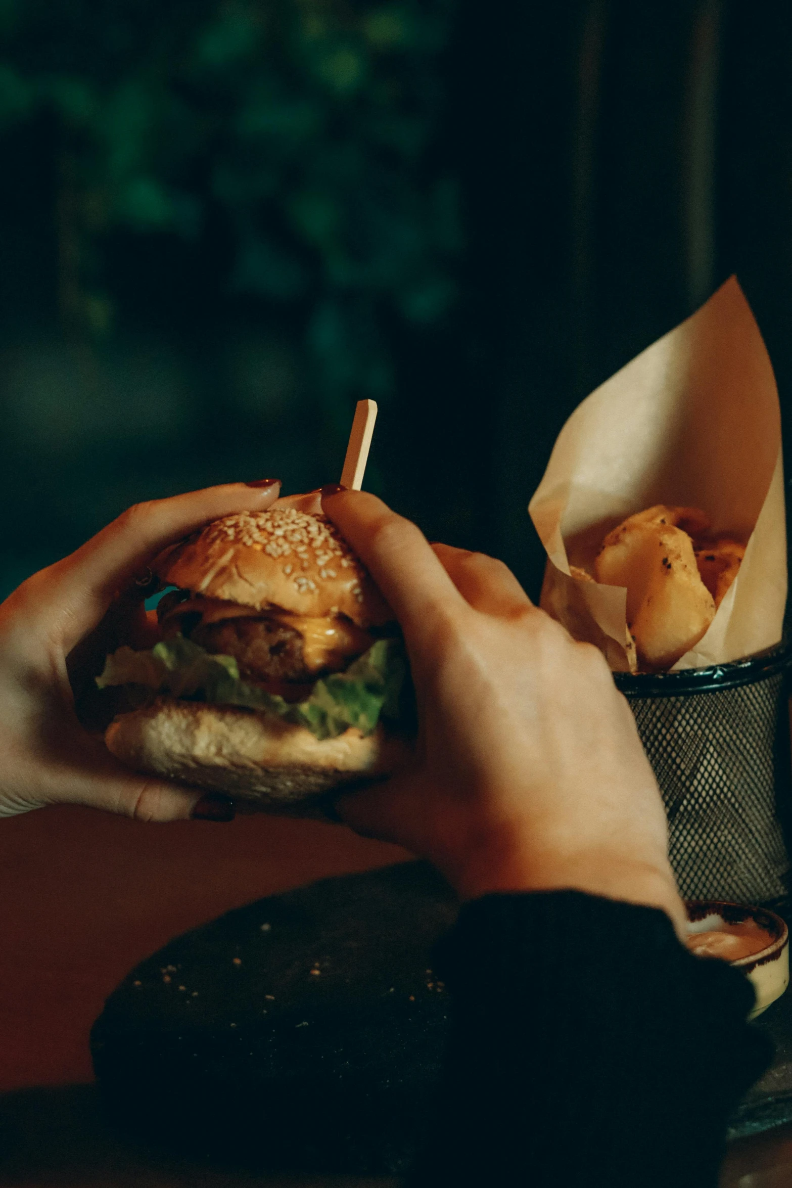 a close up of a person holding a sandwich and chips