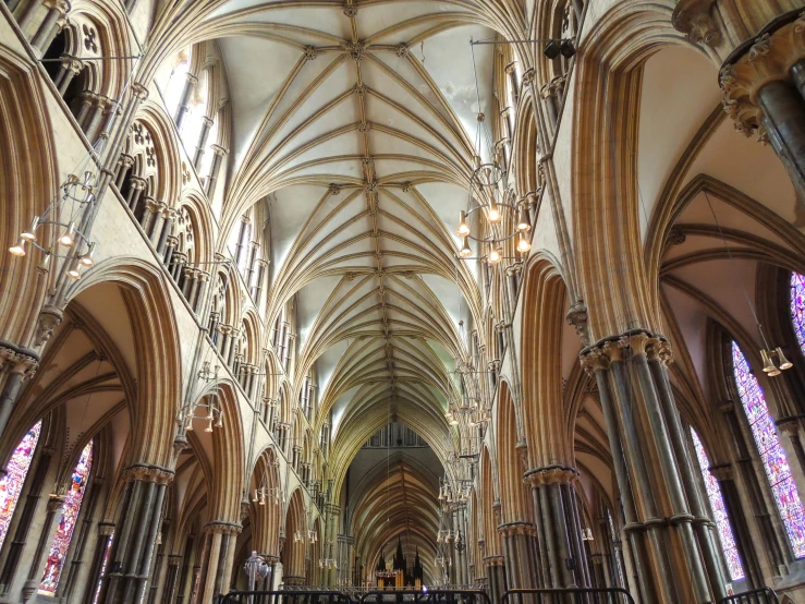 the inside of a cathedral with two altars and stained glass windows