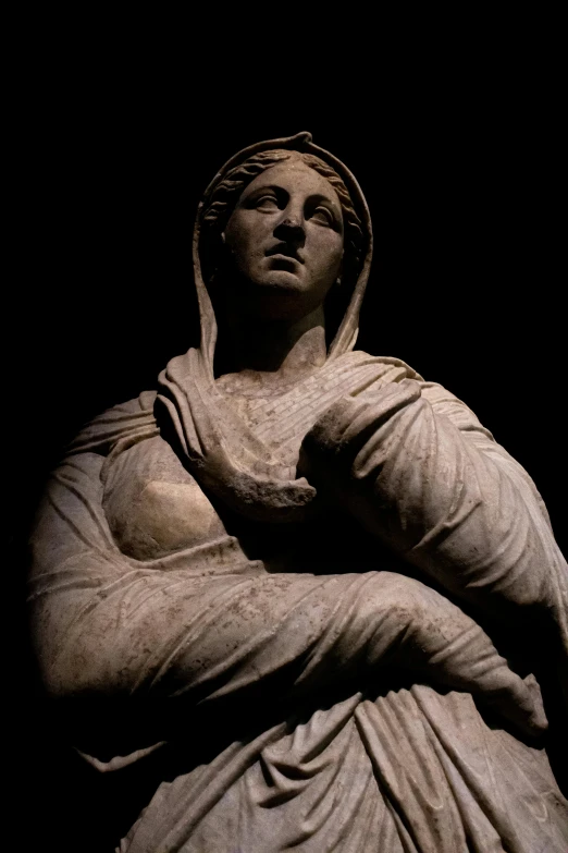 a statue of a woman wearing a dress and a headpiece