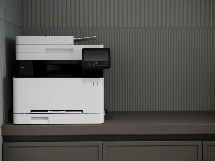 a white printer is displayed on a counter