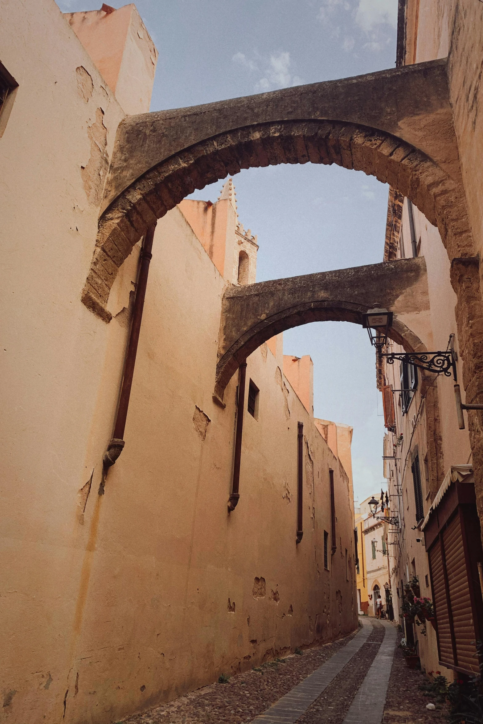 there is an archway above the street near this building