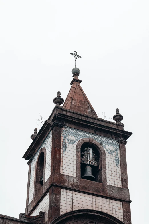 a clock tower showing the time with a bird statue above it