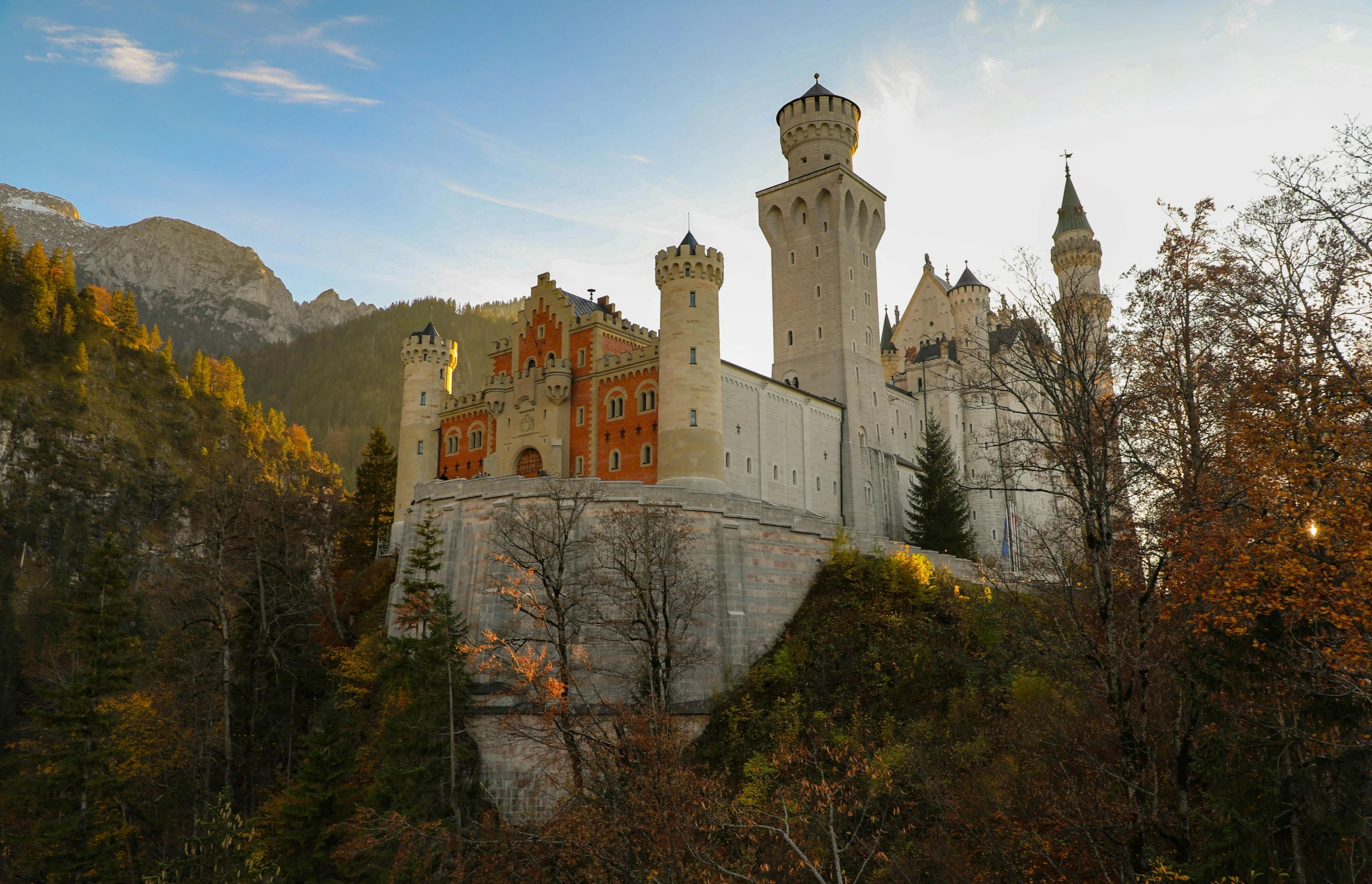 a castle sitting on top of a lush green hillside