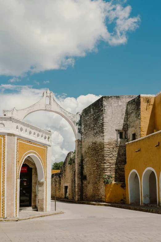 the building with arches is yellow and white