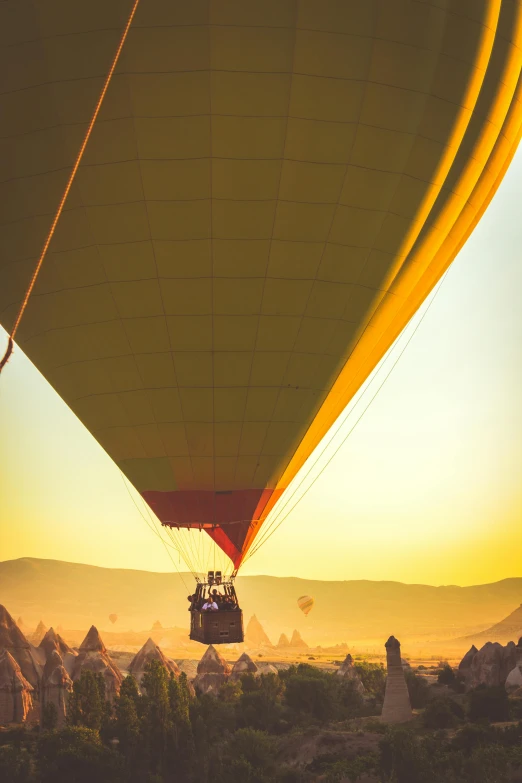 a  air balloon floating in the sky during sunset