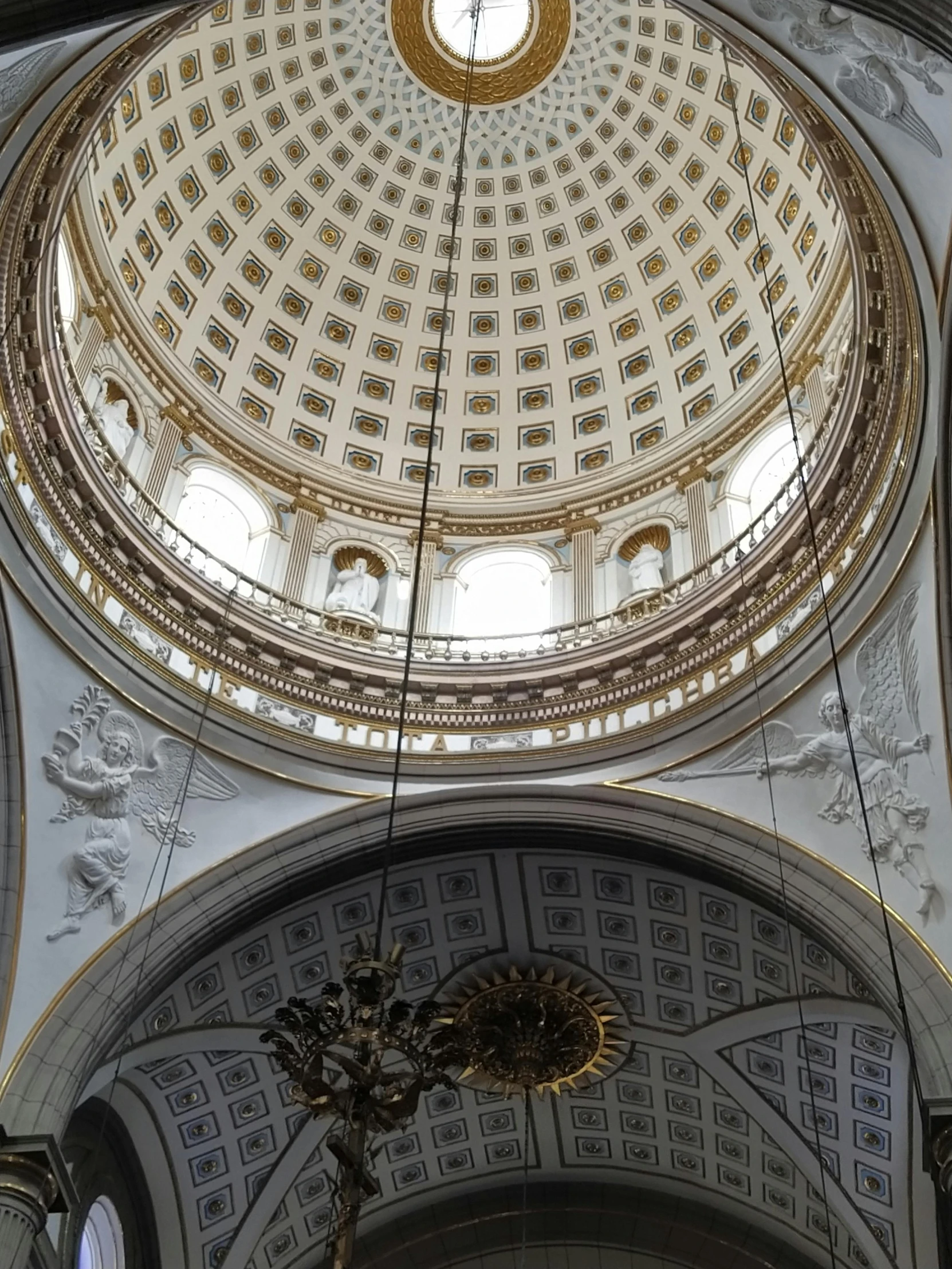 a clock that is above a ceiling in a building