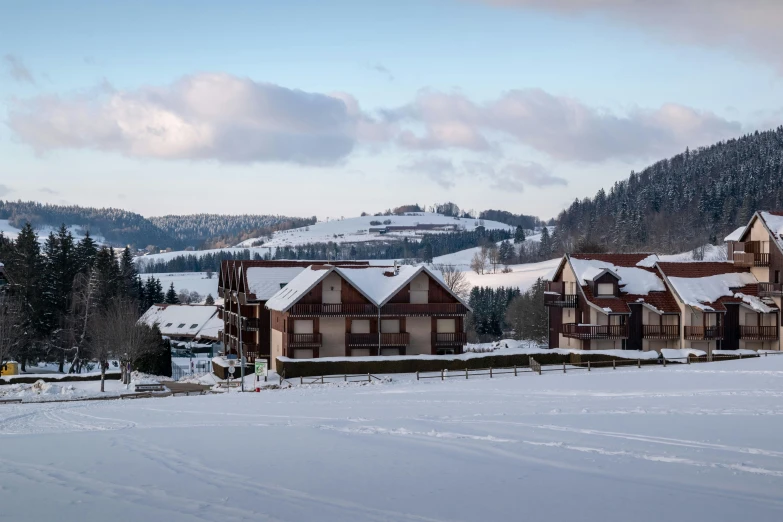 a couple of buildings on a snow covered hill