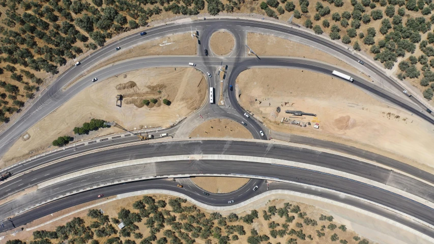 an aerial view of road curves in the desert