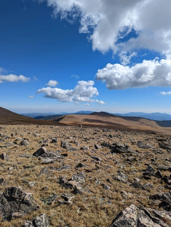 rocks on the ground below a blue sky with clouds